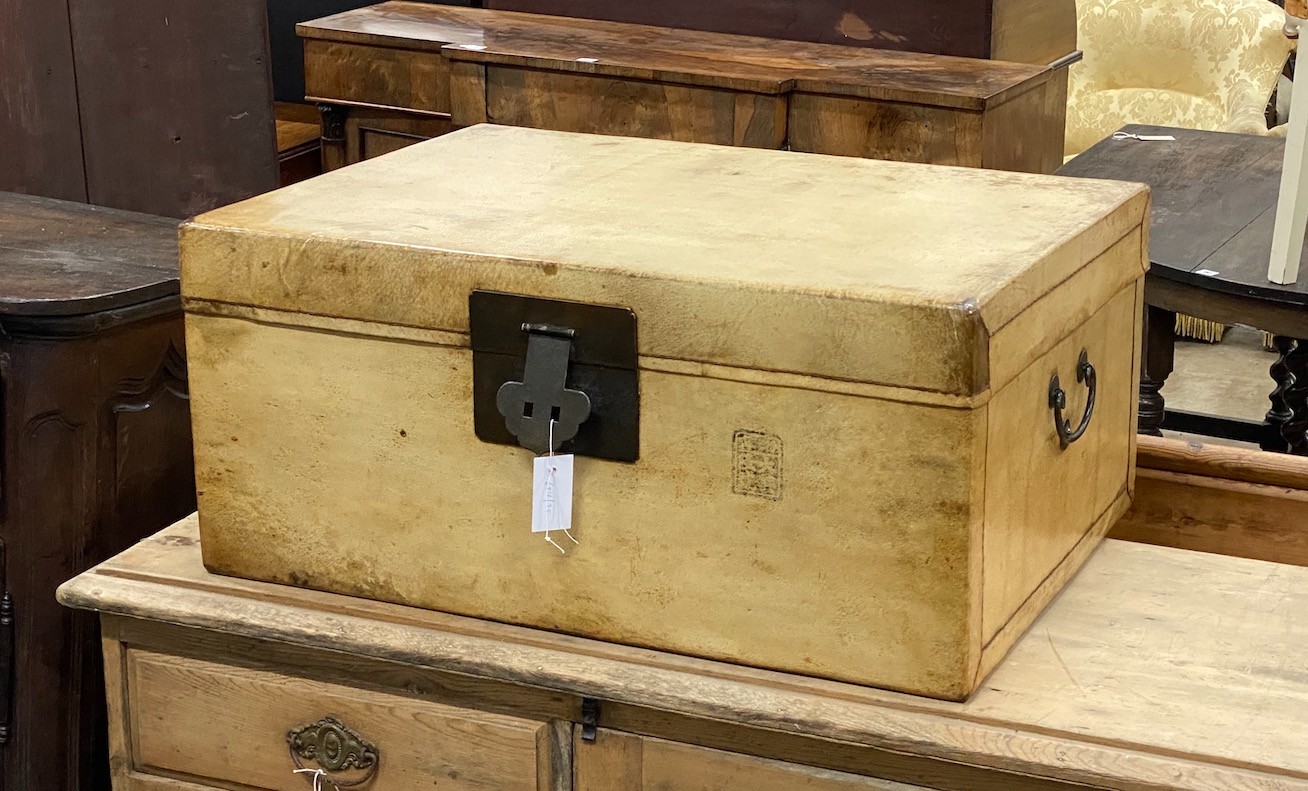A Chinese vellum covered trunk, with brass loop handles, width 76cm